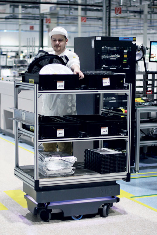 One robot collects waste materials that the operators place on the robot to keep the shop floor lean.